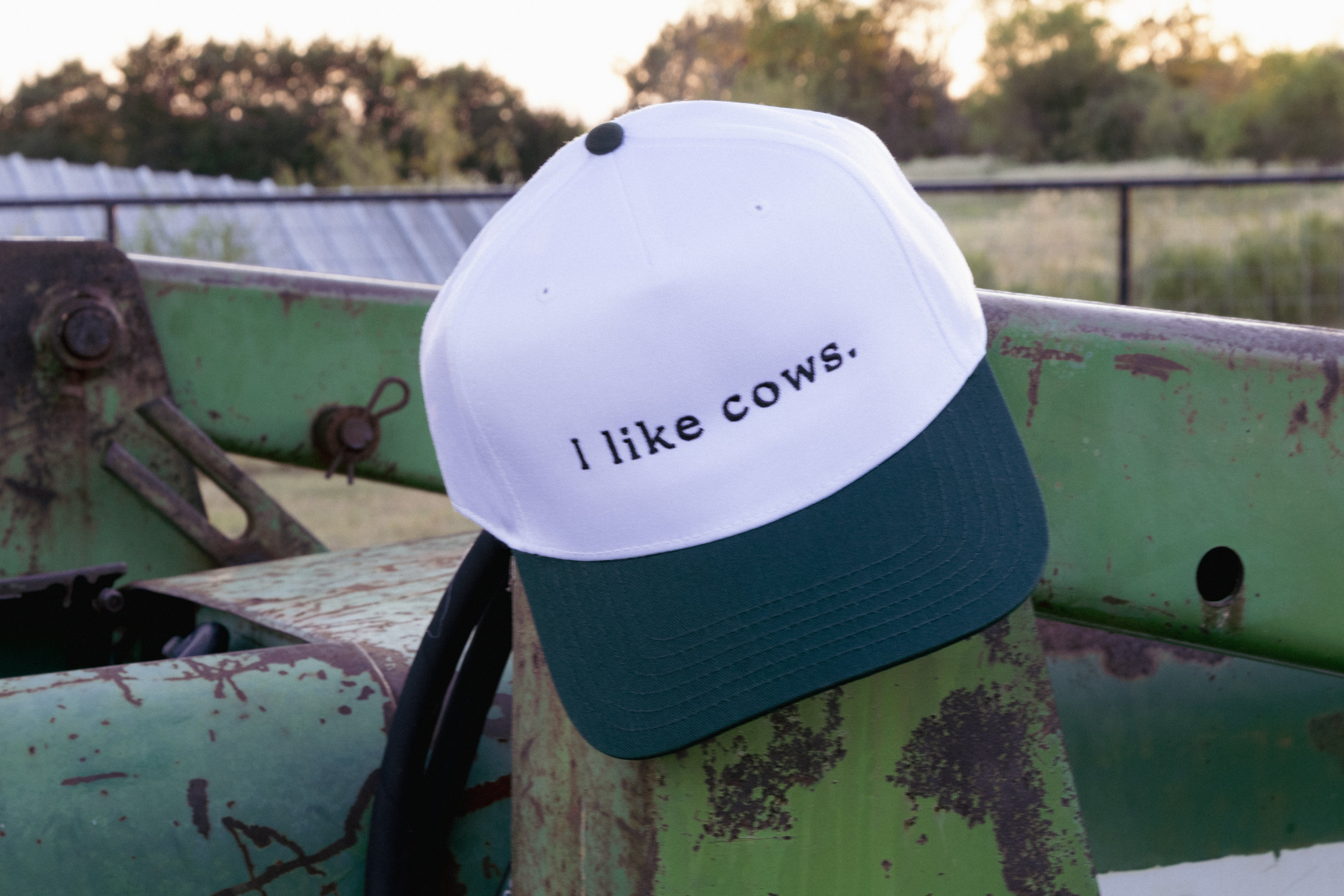 green and white 'I like cows' trucker hat