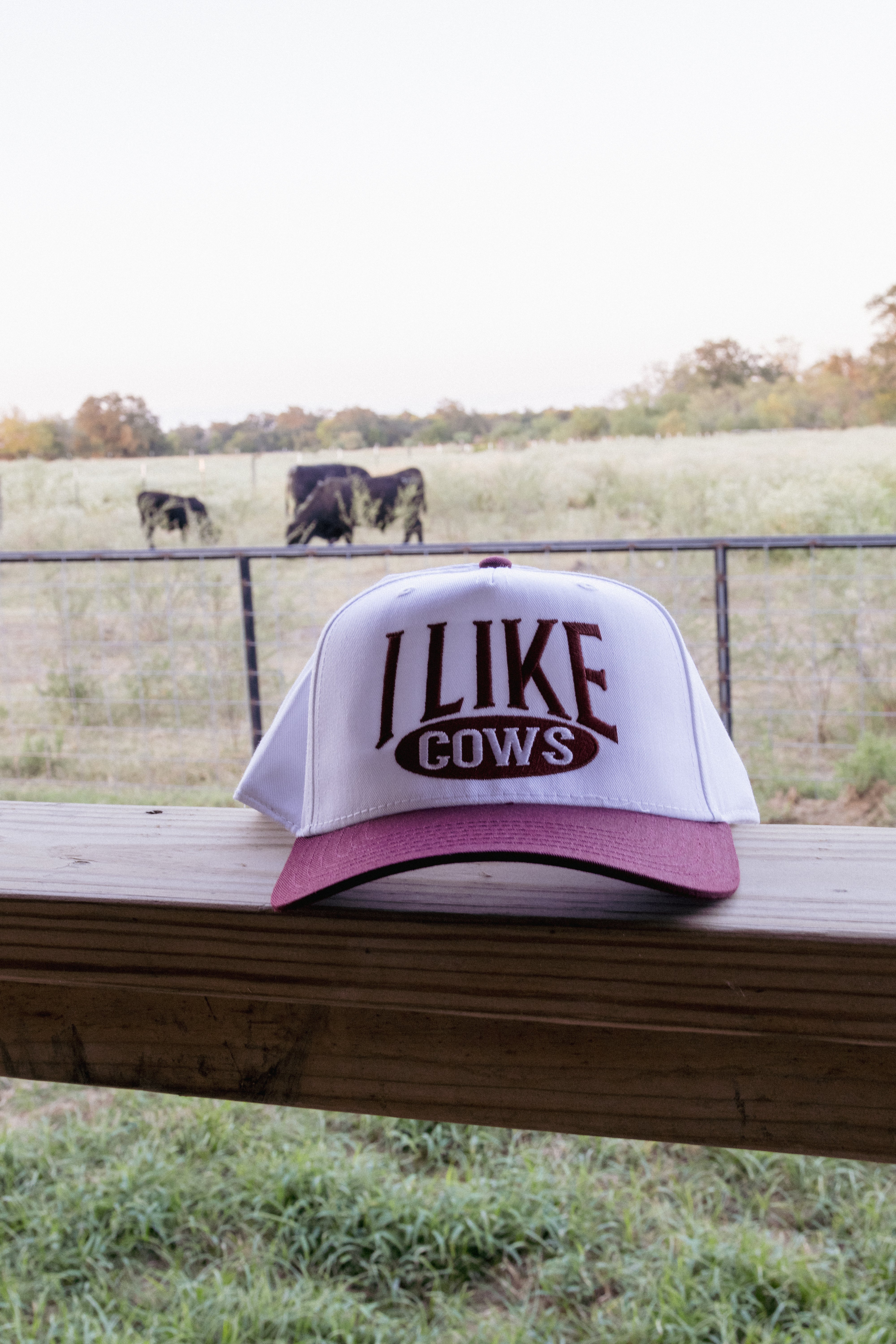 maroon and white embroidered 'i like cows' trucker hat