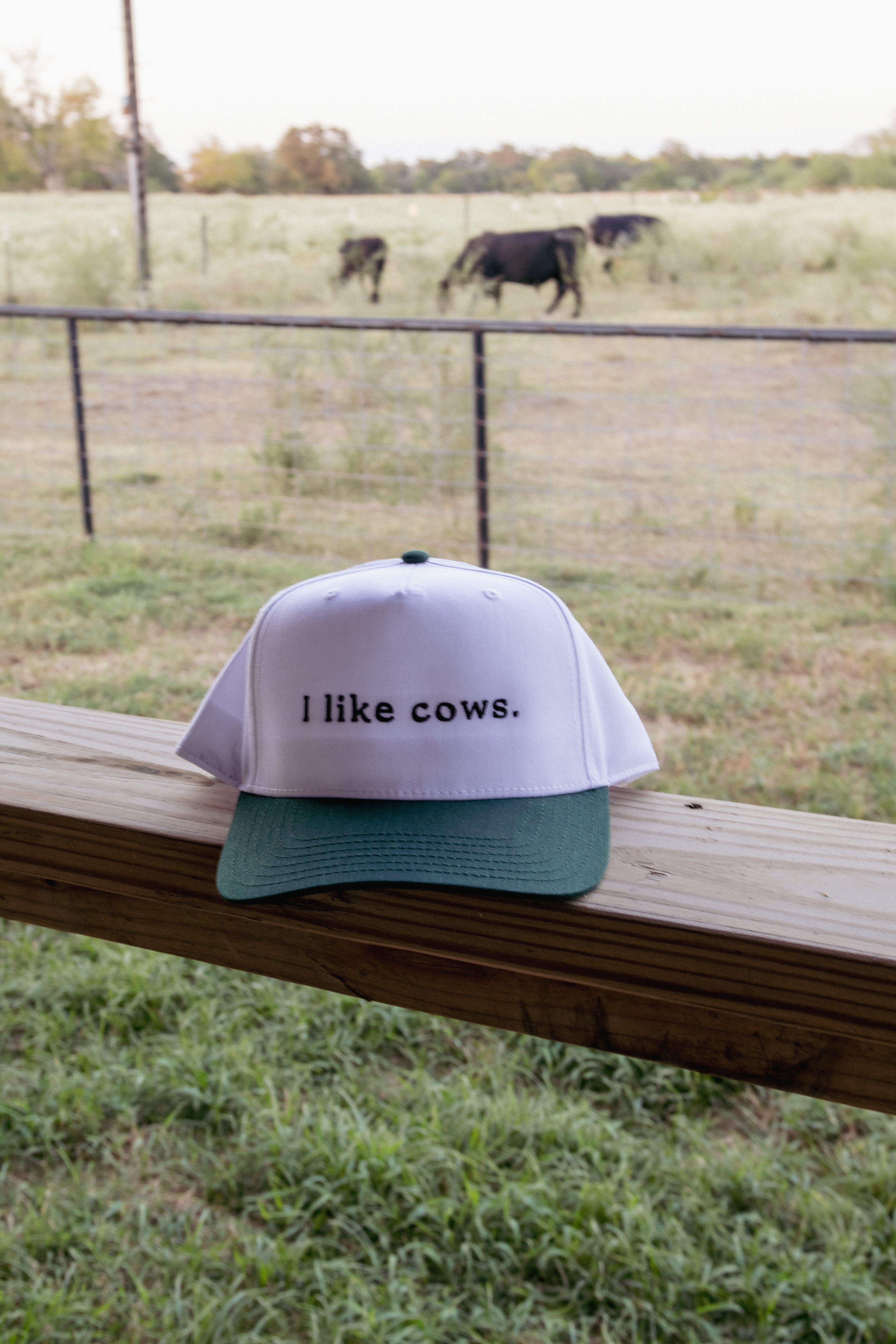 green and white embroidered 'i like cows' trucker hat