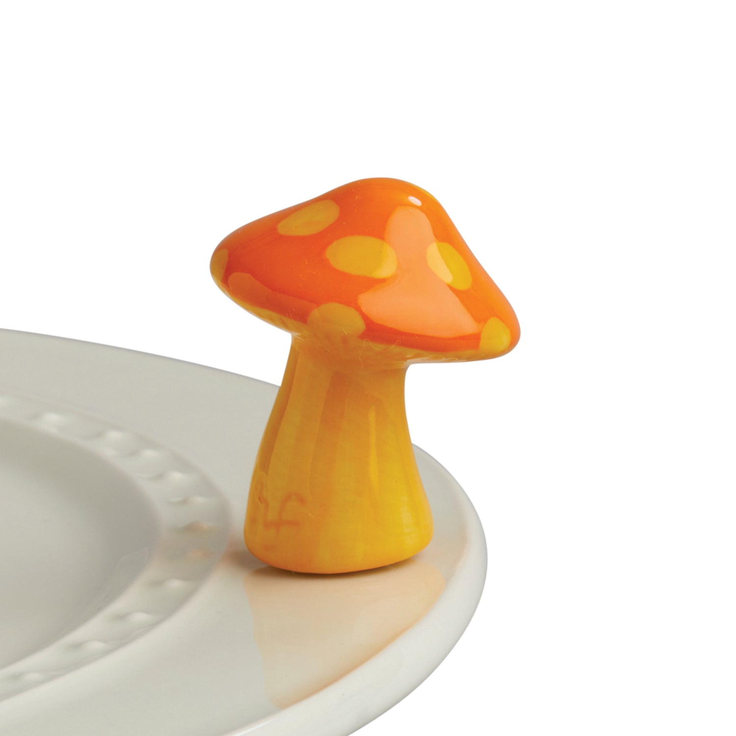 A bright orange ceramic mushroom-shaped holder for a plate, with a simplistic and quirky design.