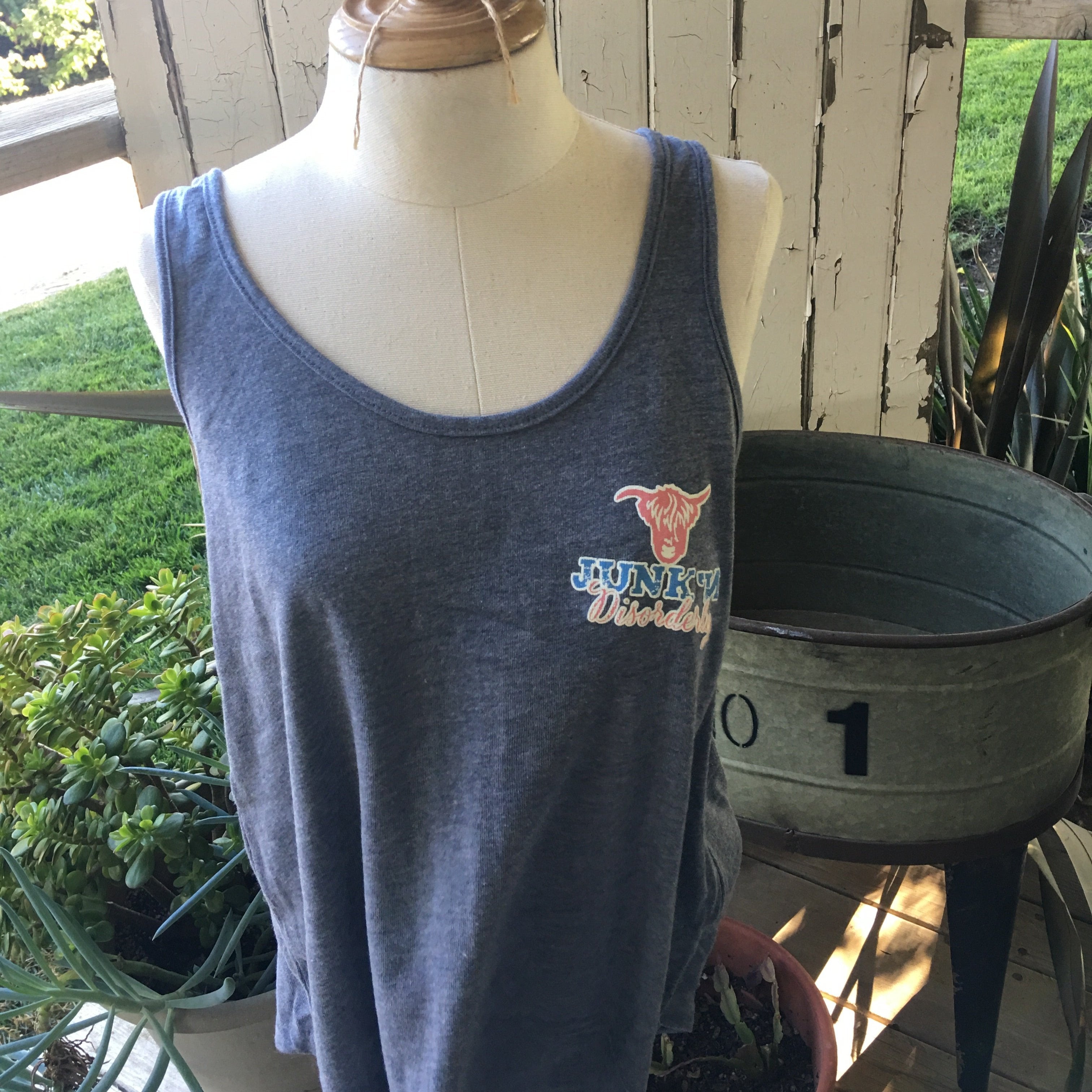 A dark blue, short-sleeved, round-neck tank top displayed on a mannequin, featuring a graphic on the front.