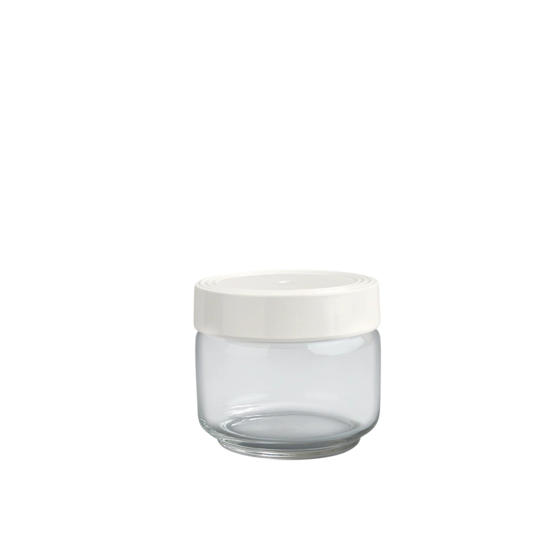 A clear glass canister with a white lid.
