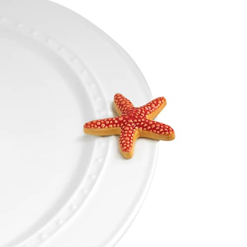 A decor piece shaped like a starfish on a white plate.