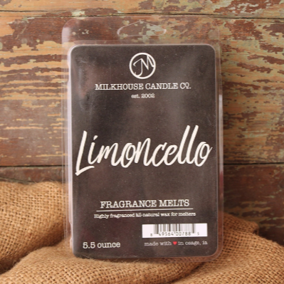 A package of 'Limoncello' fragrance wax melts from Milkhouse Candle Co., placed on a wooden surface with a burlap fabric underneath.